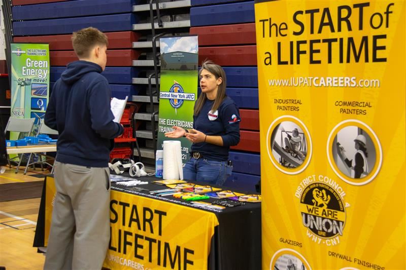  A student talks with a representative at the Trades & Unions expo.